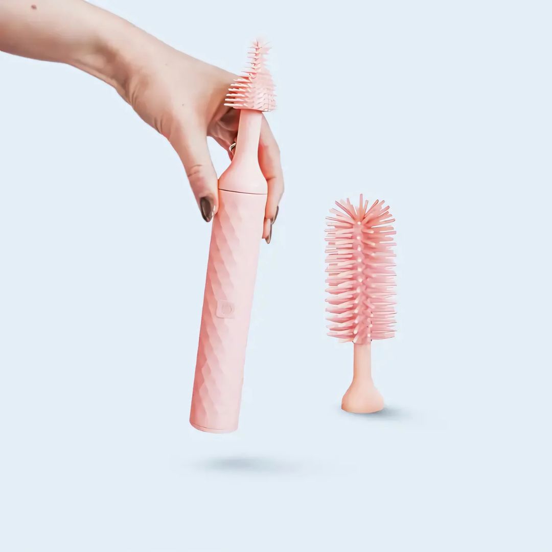 A pink 360 bottle brush with its components displayed in two positions, showing the brush attached to the bottle and separately.